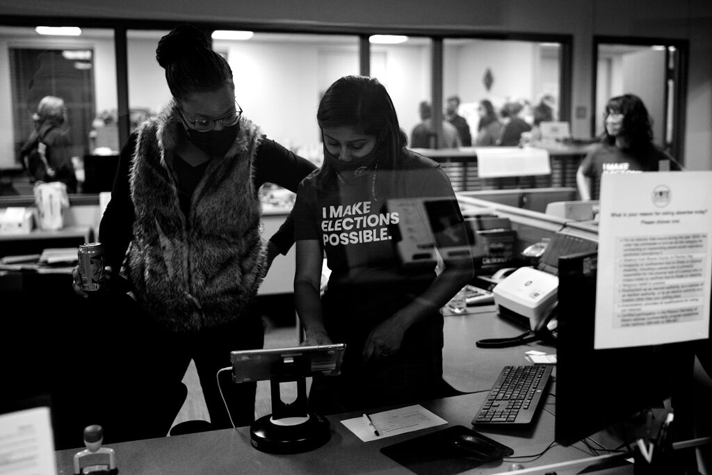 Jessica Owens and Ragini Algole work on a poll pad before polls open on Election Day 2020 at the Boone County Clerk’s Office